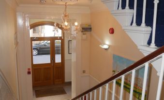 Entrance hall and staircase at Pacific Hotel